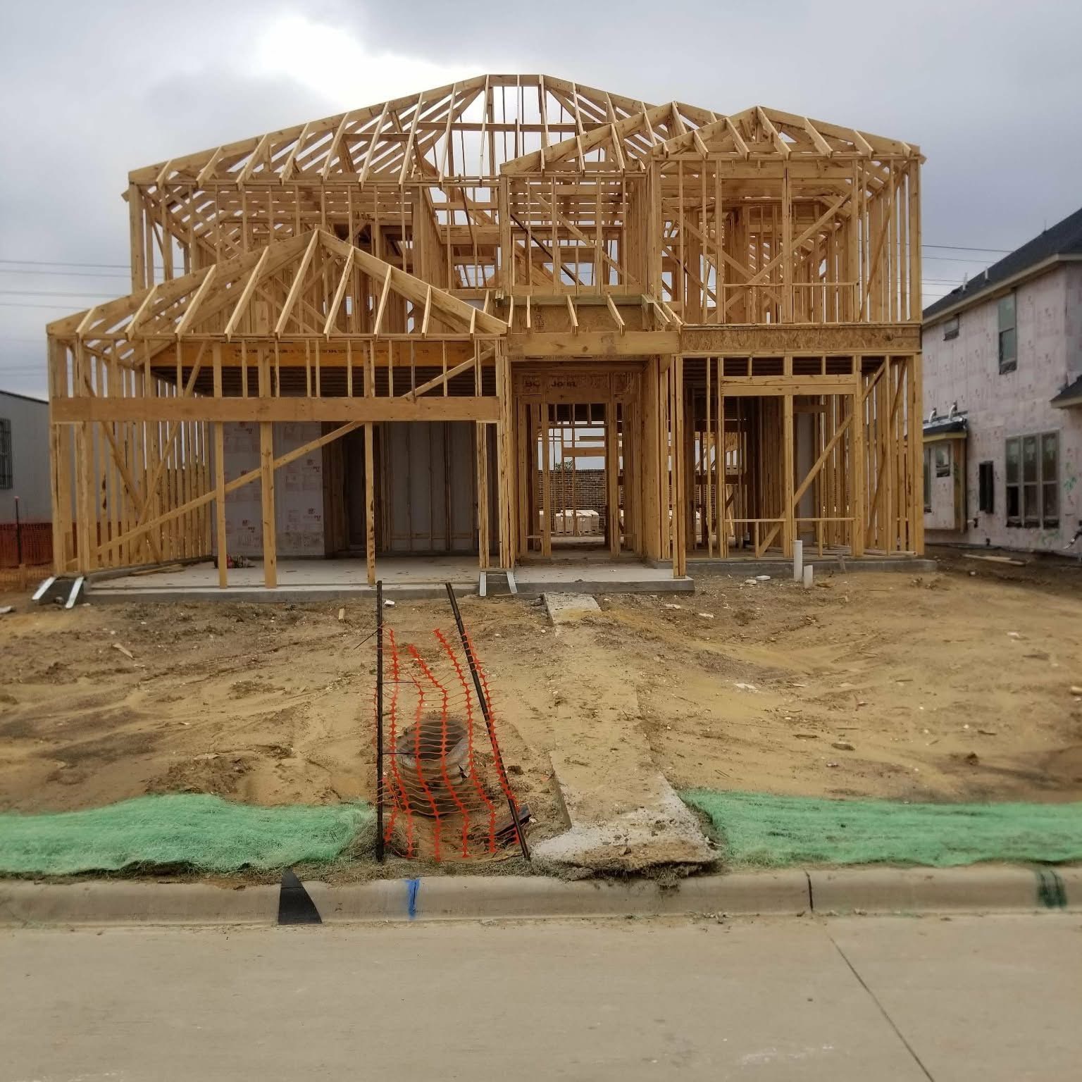 Custom home in active framing stage by Armadillo Homes & Construction